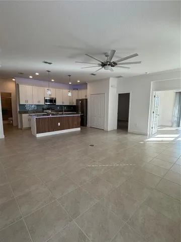a large kitchen with a large counter top and stainless steel appliances