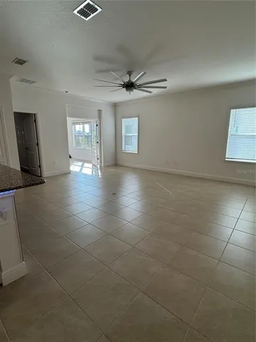 a view of a livingroom with a ceiling fan and window