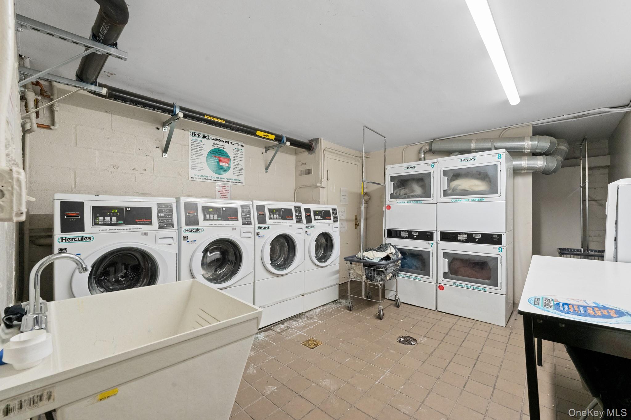 2545 Sedgwick Avenue, Unit 4H Bronx, NY 10468 - Photo 9 of 10 a utility room with dryer and washer