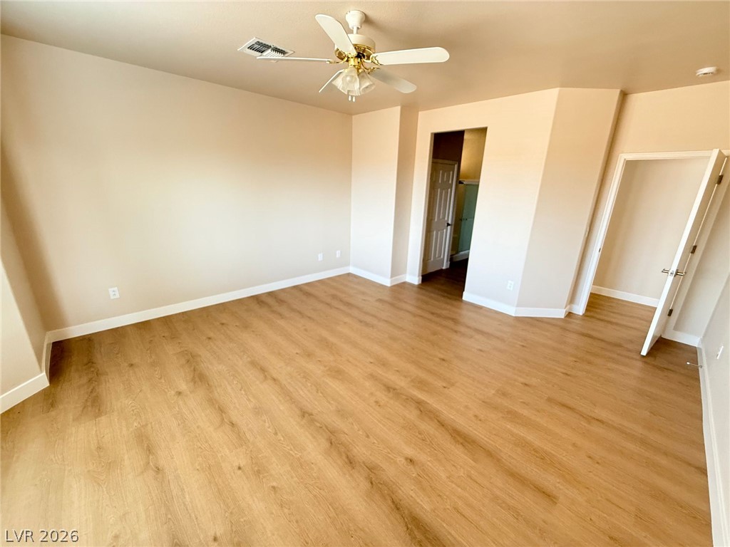 3036 Fort Stanwix Road Henderson, NV 89052 - Photo 6 of 18 Gleaming wood-look floors anchor this airy bedroom complete with clean lines and classic trim.