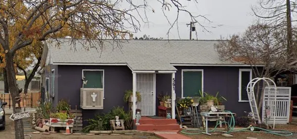 a front view of a house with parking area