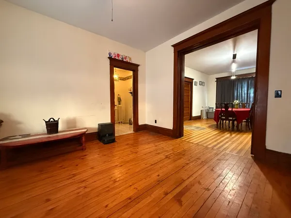 a view of a living room with hardwood floor and furniture