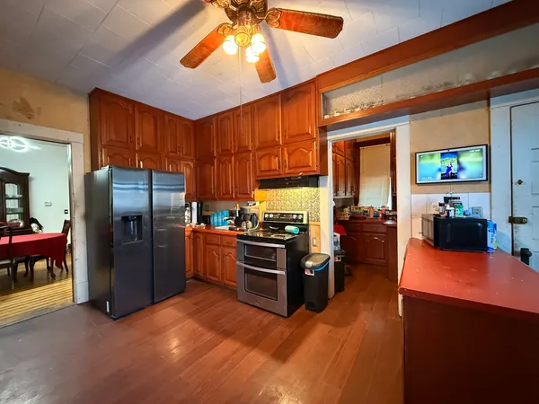 a kitchen with stainless steel appliances kitchen island granite countertop a refrigerator and a stove