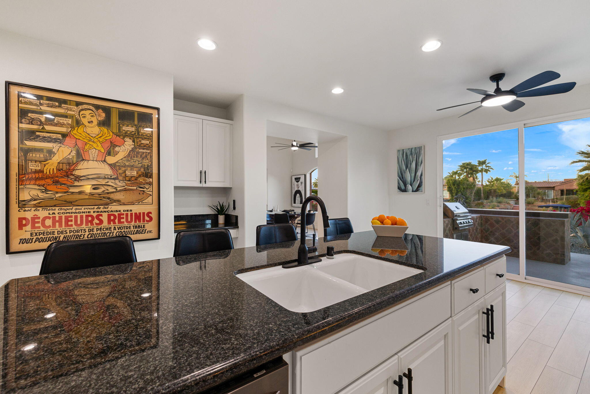 6 Via Santa Ramona Rancho Mirage, CA 92270 - Photo 12 of 60 a kitchen with stainless steel appliances granite countertop a sink and a white cabinets