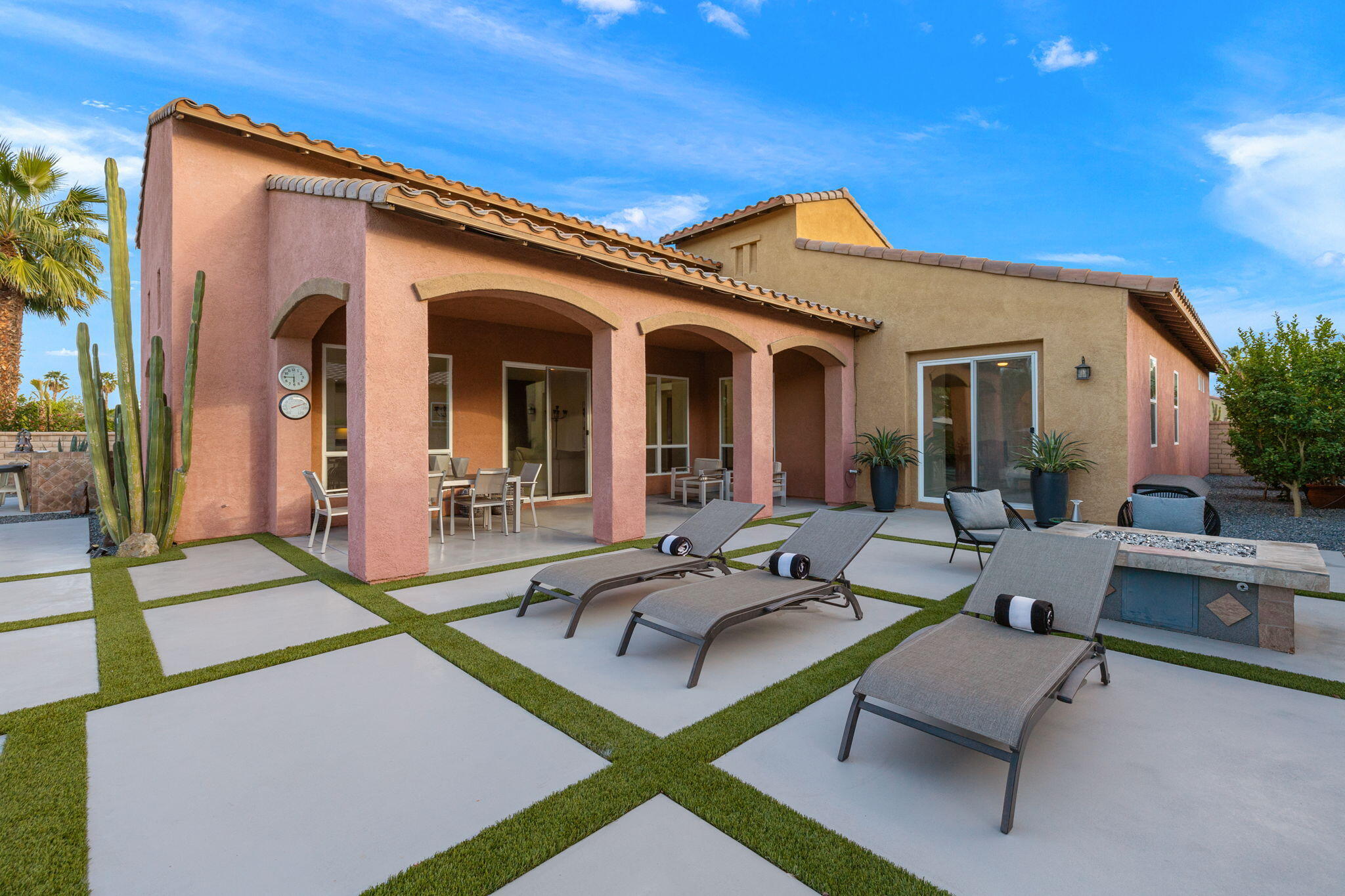 6 Via Santa Ramona Rancho Mirage, CA 92270 - Photo 48 of 60 a view of a patio with couches table and chairs with potted plants