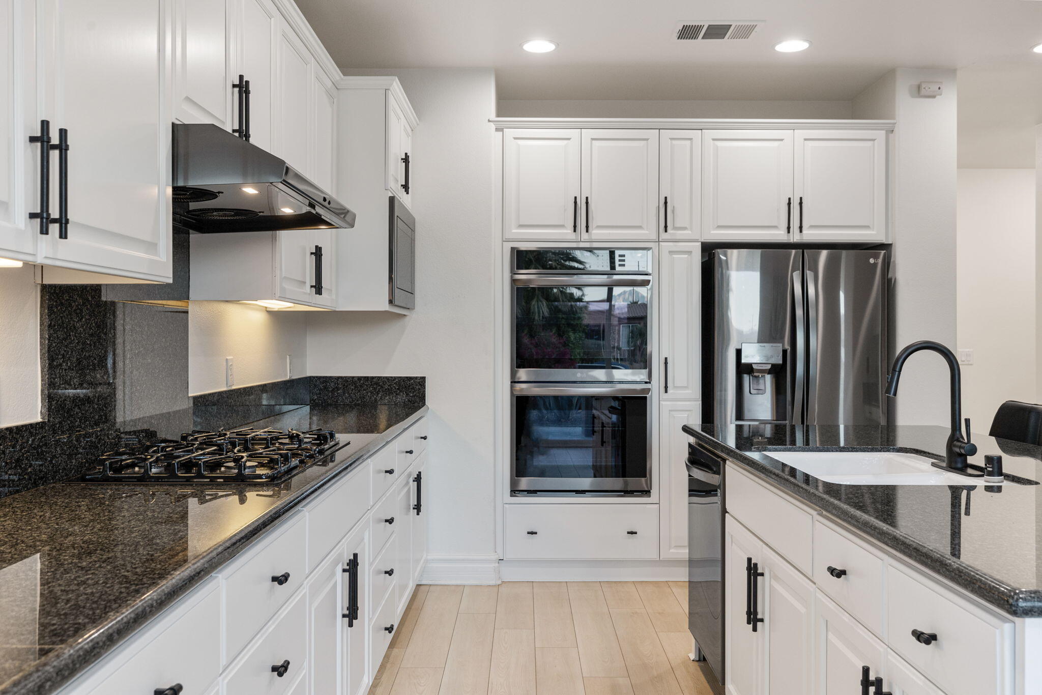 6 Via Santa Ramona Rancho Mirage, CA 92270 - Photo 10 of 60 a kitchen with stainless steel appliances kitchen island granite countertop a stove a sink and a refrigerator