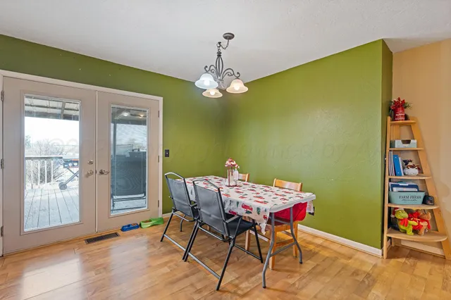 a view of a dining room with furniture and chandelier