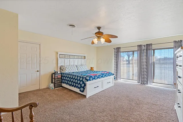 a spacious bedroom with a bed and window