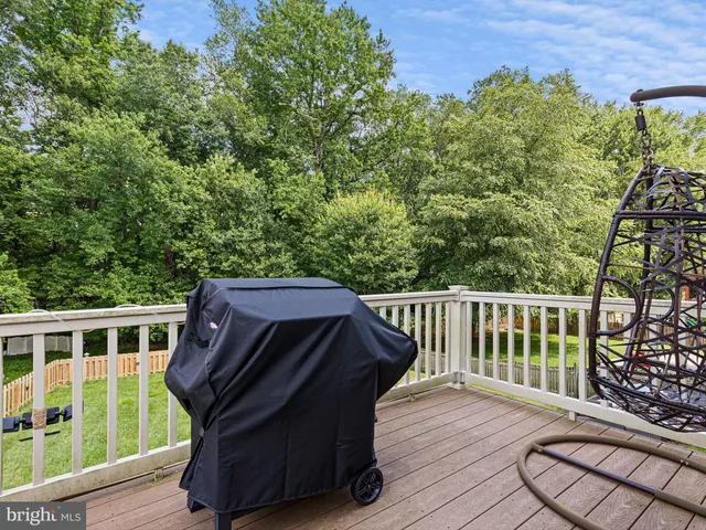 a view of a wooden deck and a yard