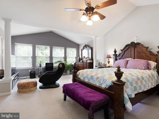 a spacious bedroom with bed and a chandelier