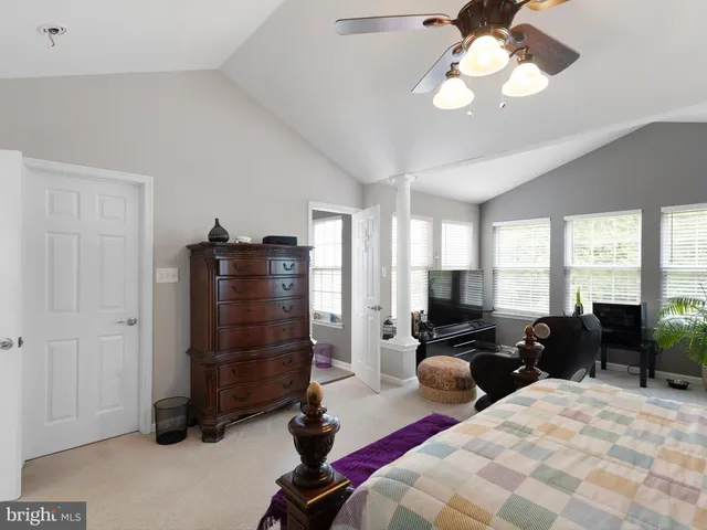 a bedroom with a bed a couch and dresser