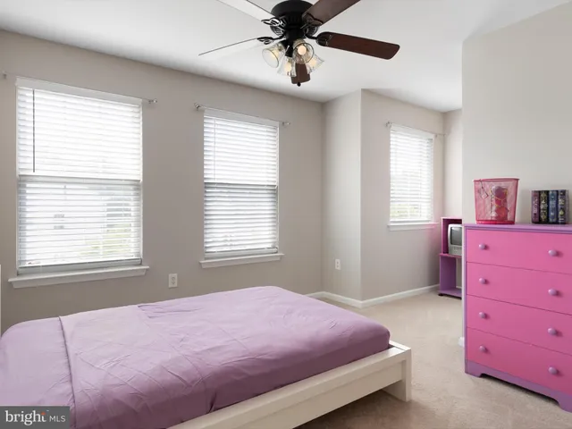 a bedroom with a bed dresser and a window