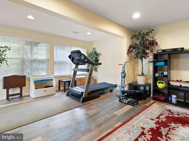 a living room with furniture gym equipment and a table