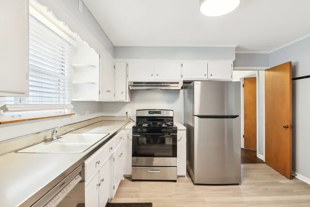 a kitchen with a refrigerator and a sink