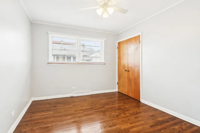 an empty room with wooden floor and window