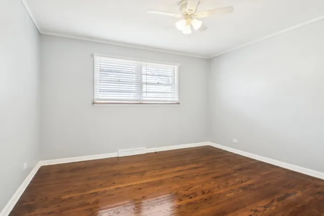 an empty room with wooden floor and closet