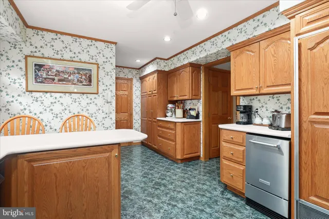 a view of a kitchen with fridge and wooden floor
