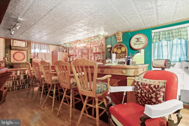 a living room with furniture a clock and a large window