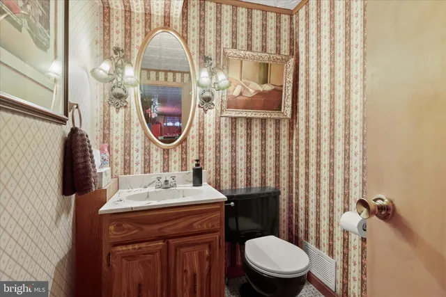 a bathroom with a sink a toilet and a mirror