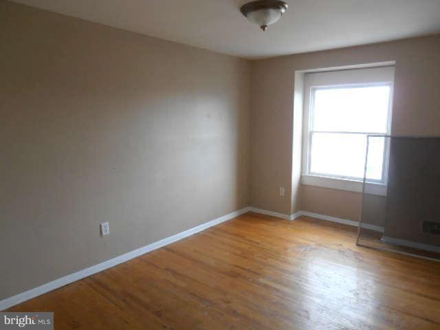 2102 Graythorn Road Middle River, MD 21220 - Photo 16 of 18 an empty room with wooden floor and windows
