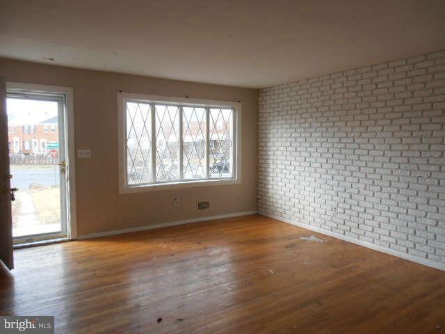 2102 Graythorn Road Middle River, MD 21220 - Photo 3 of 18 a view of an empty room with wooden floor and a window