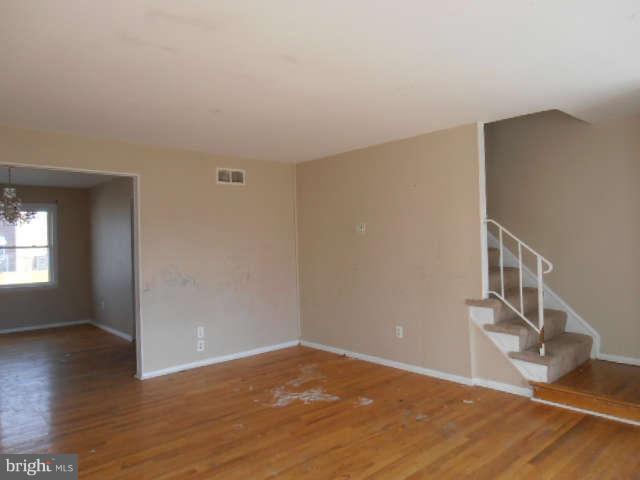 2102 Graythorn Road Middle River, MD 21220 - Photo 4 of 18 a view of an empty room with wooden floor and a window