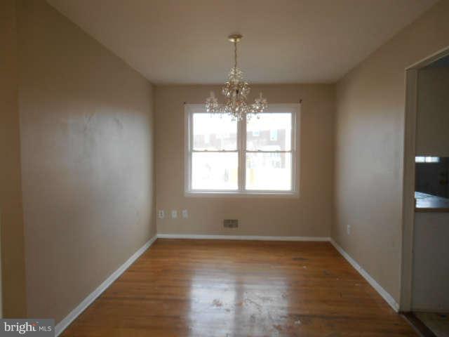 2102 Graythorn Road Middle River, MD 21220 - Photo 5 of 18 an empty room with wooden floor and windows
