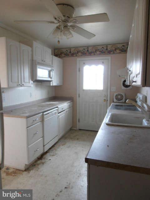 2102 Graythorn Road Middle River, MD 21220 - Photo 7 of 18 a kitchen with a sink stove and cabinets