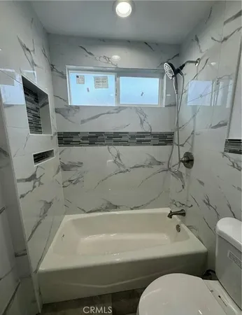 a bathroom with a toilet and a bathtub