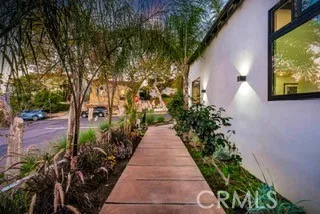 a view of a pathway that has potted plants