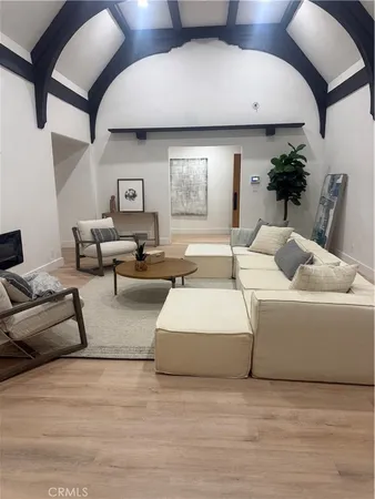 a living room with furniture and flowers