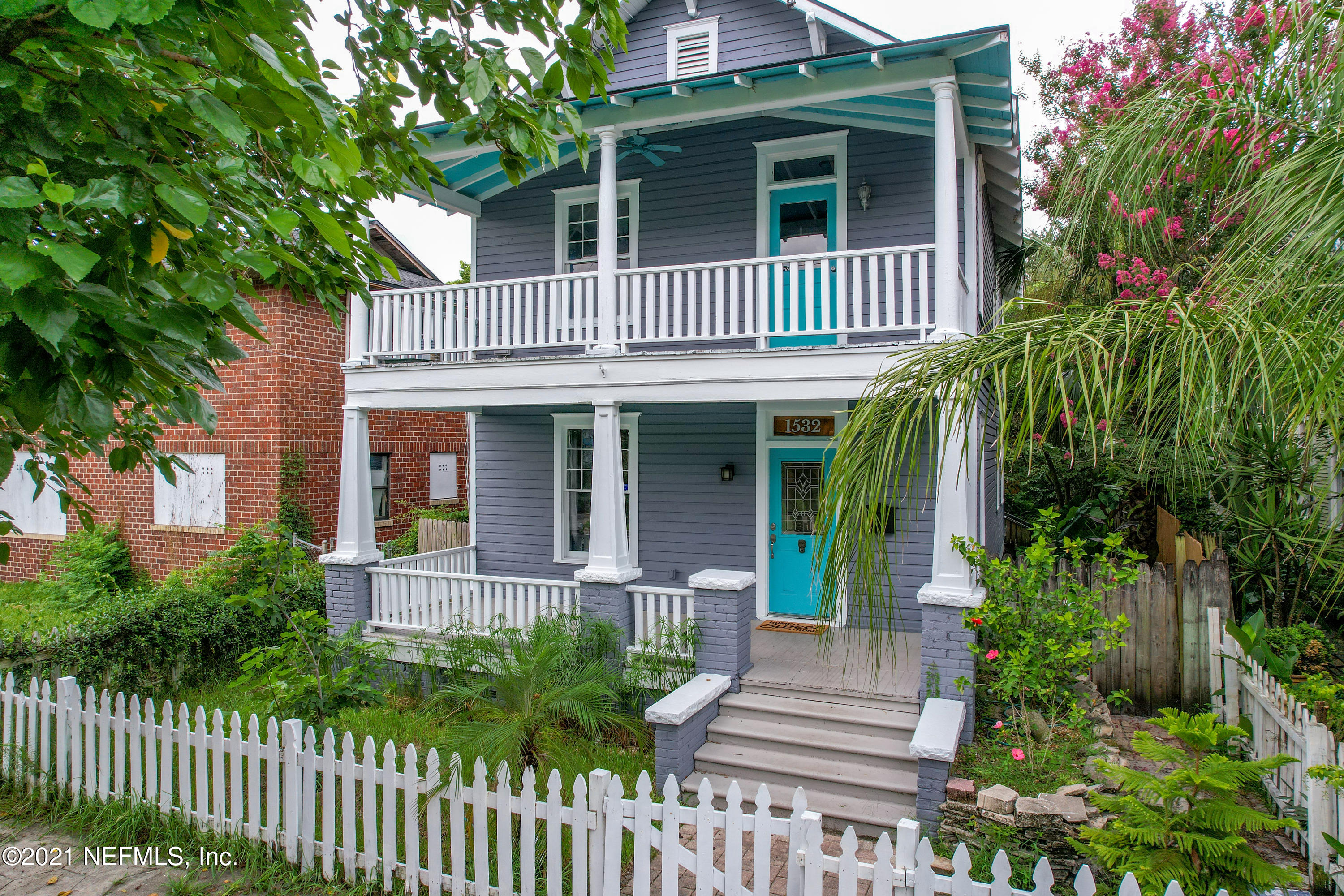 1532 Perry Street Jacksonville, FL 32206 - Photo 1 of 58 a view of a brick house with large windows plants and large trees
