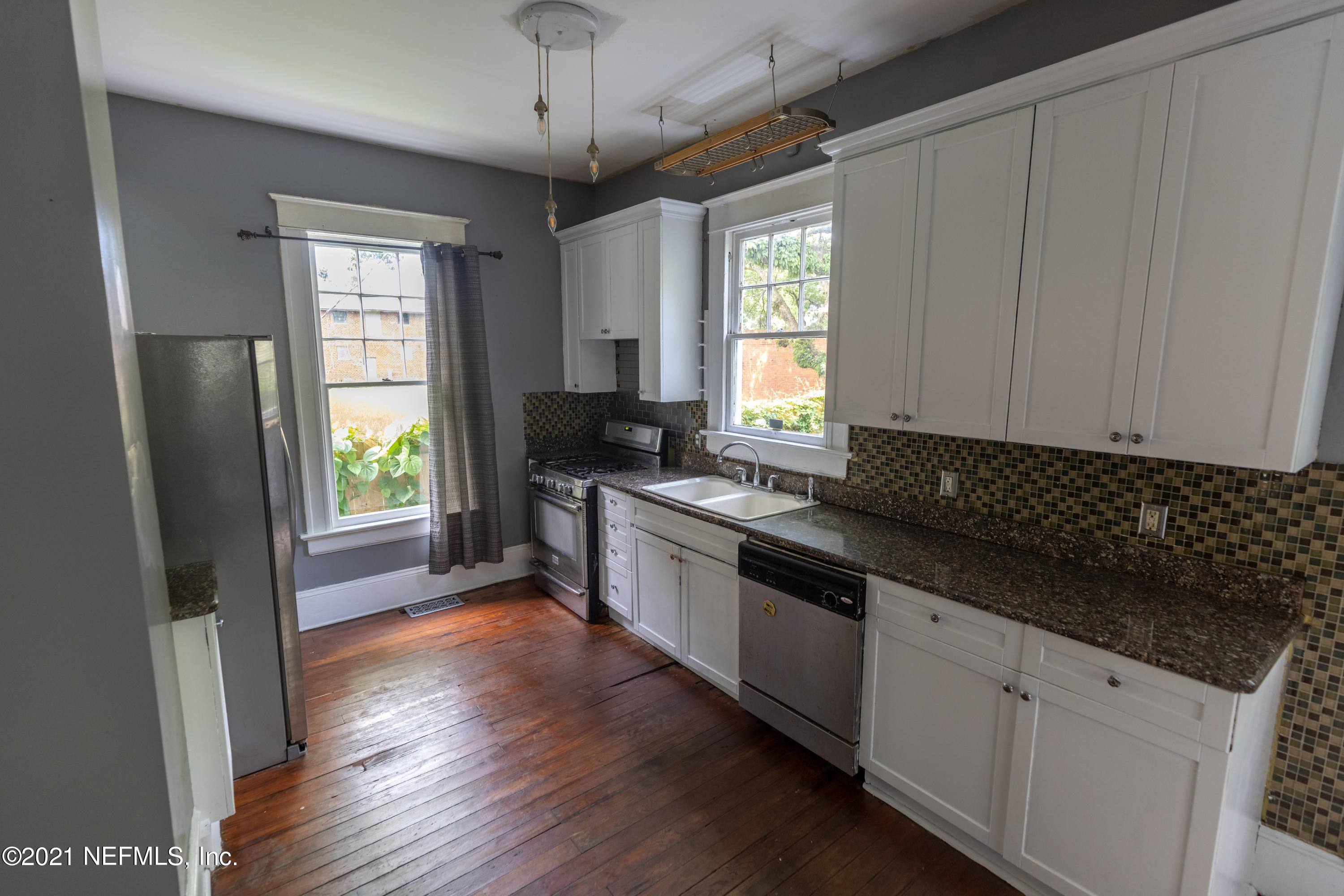 1532 Perry Street Jacksonville, FL 32206 - Photo 13 of 58 a kitchen with granite countertop a stove a sink and a refrigerator