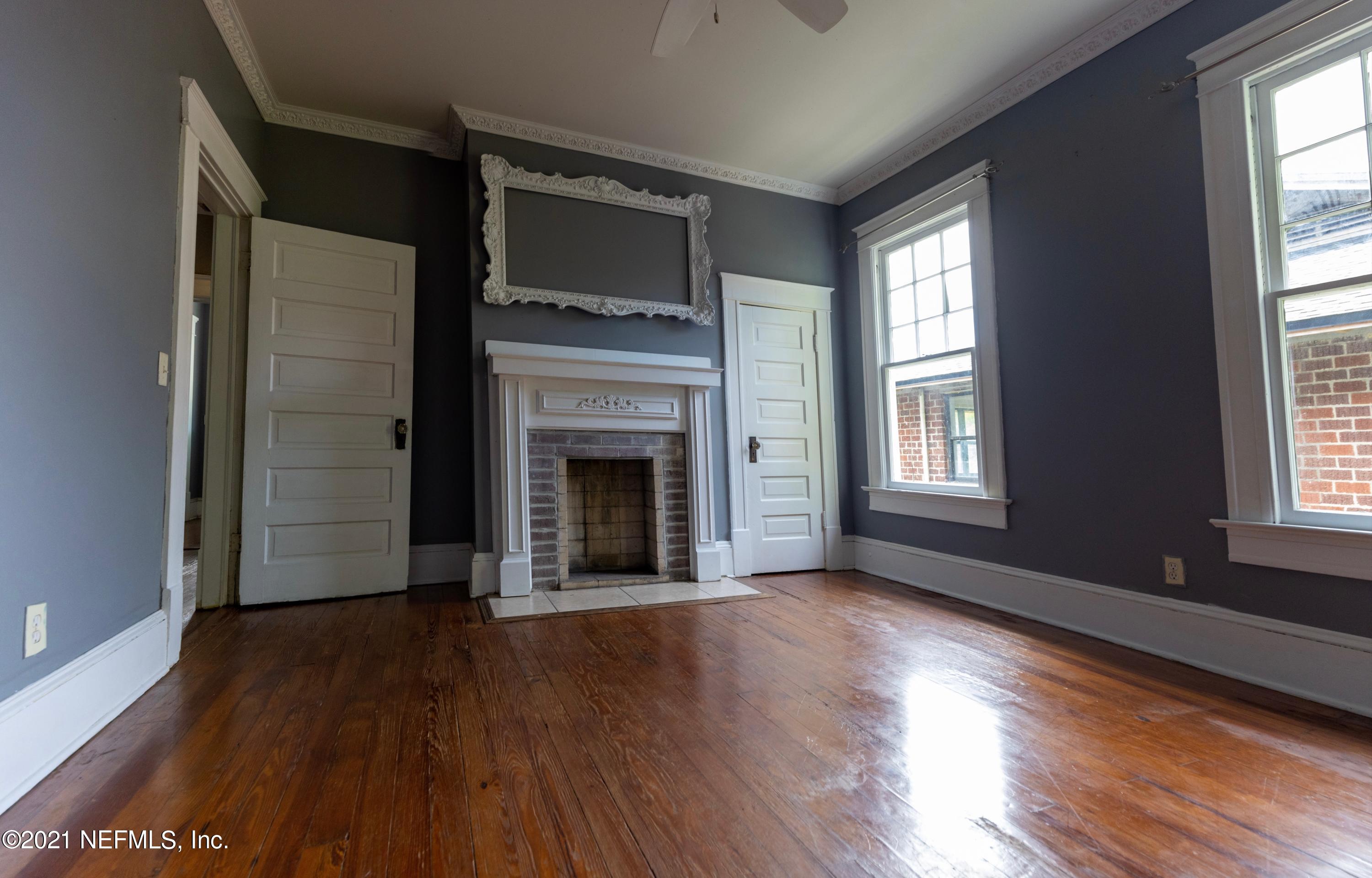 1532 Perry Street Jacksonville, FL 32206 - Photo 25 of 58 wooden floor fireplace and windows in an empty room