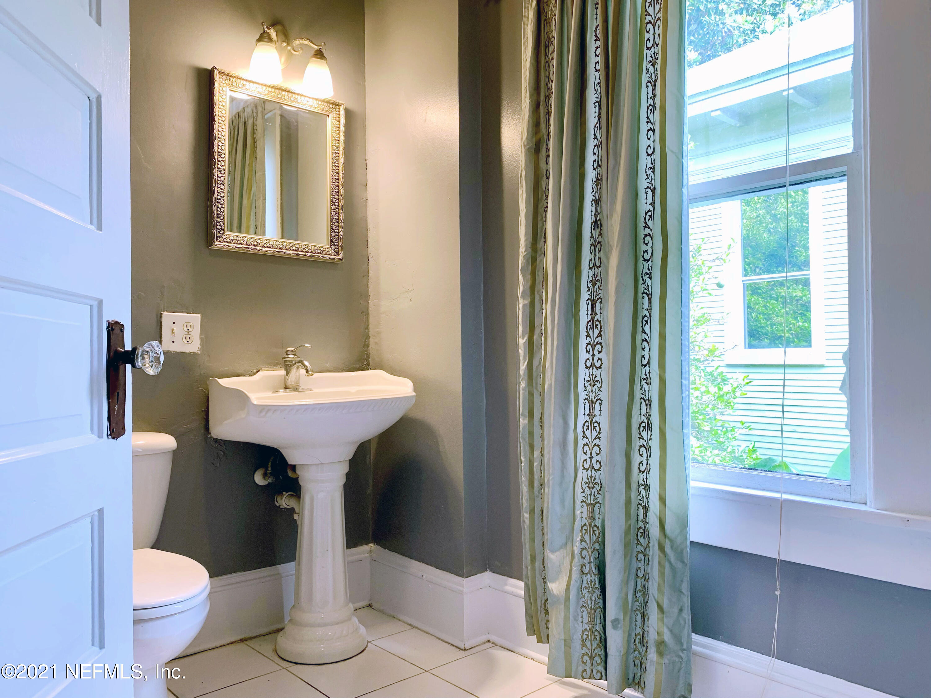 1532 Perry Street Jacksonville, FL 32206 - Photo 29 of 58 a bathroom with a sink toilet and a mirror