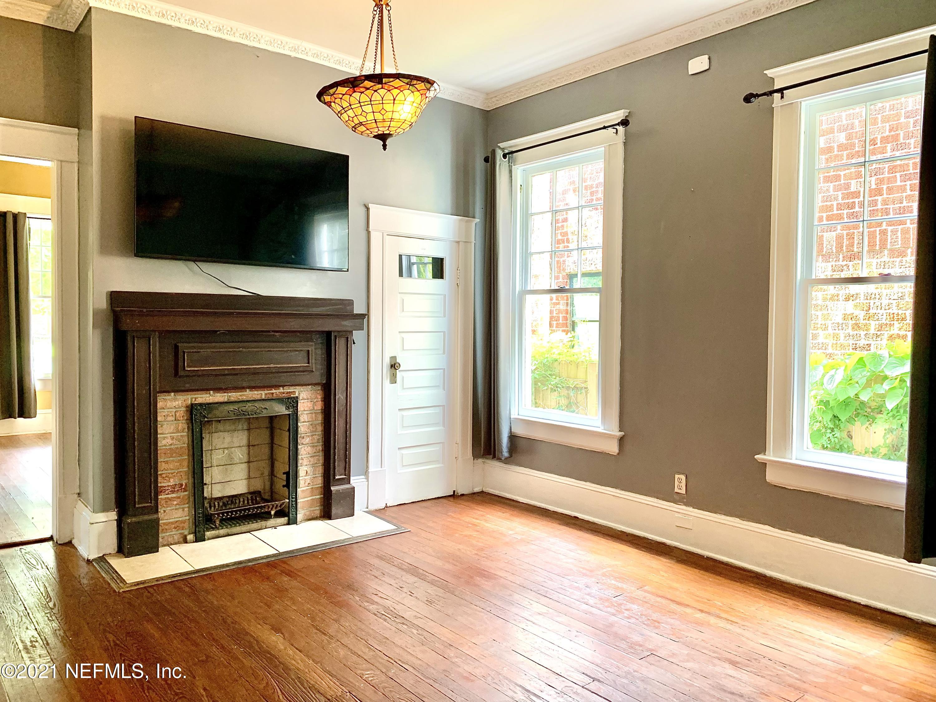 1532 Perry Street Jacksonville, FL 32206 - Photo 9 of 58 a view of an empty room with wooden floor fireplace and a window