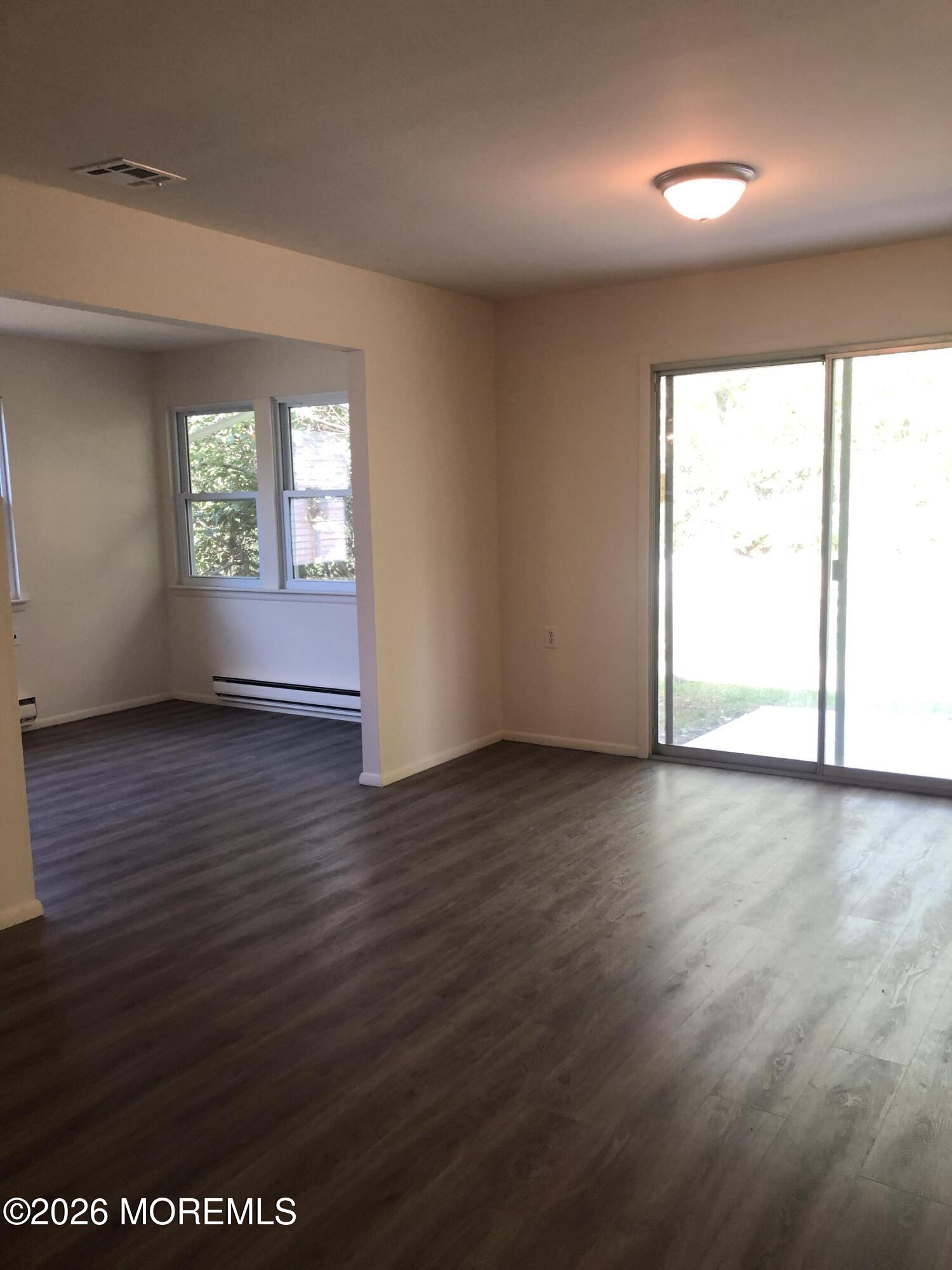 6 Dickinson Road Brick, NJ 08724 - Photo 9 of 17 an empty room with wooden floor and windows