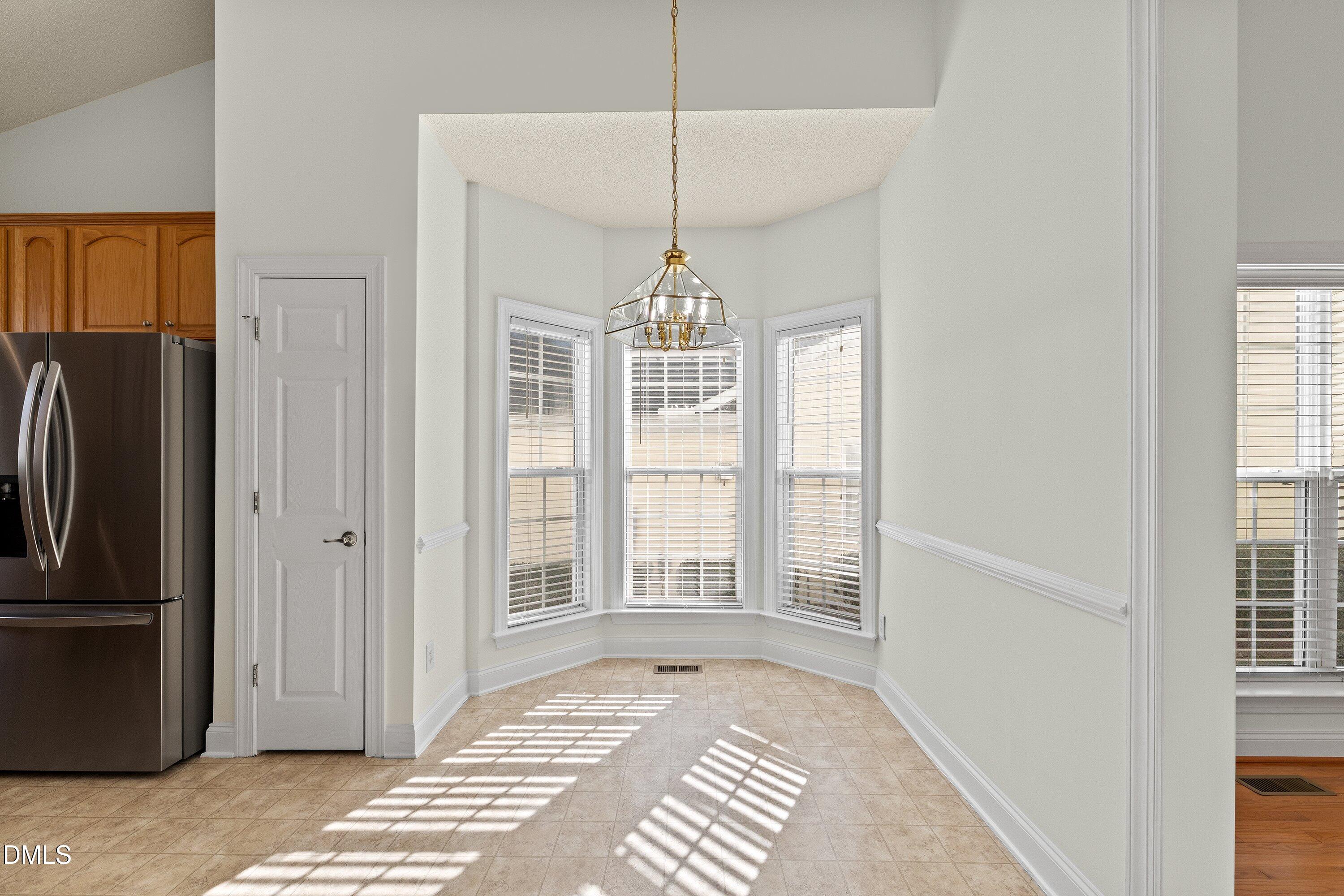 105 Rockport Ridge Way Cary, NC 27519 - Photo 4 of 43 a view of a hallway with windows and chandelier