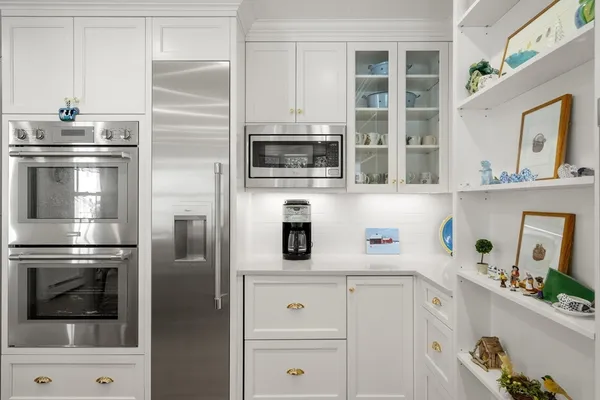 a kitchen with cabinets and stainless steel appliances