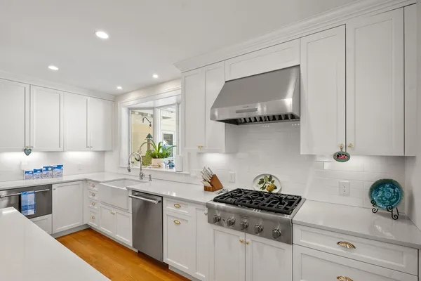 a kitchen with a white cabinets and appliances