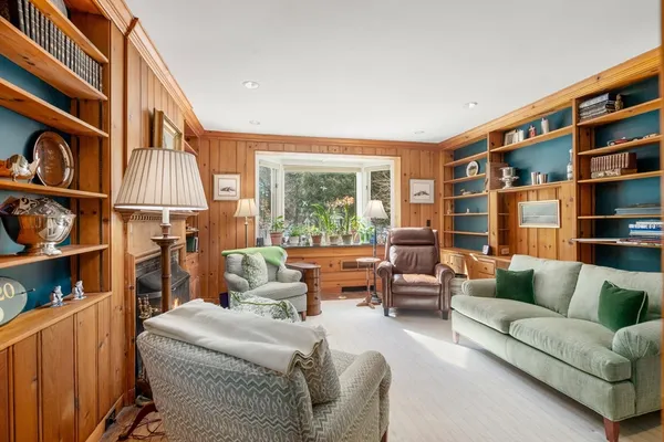 a living room with furniture a rug and a large window