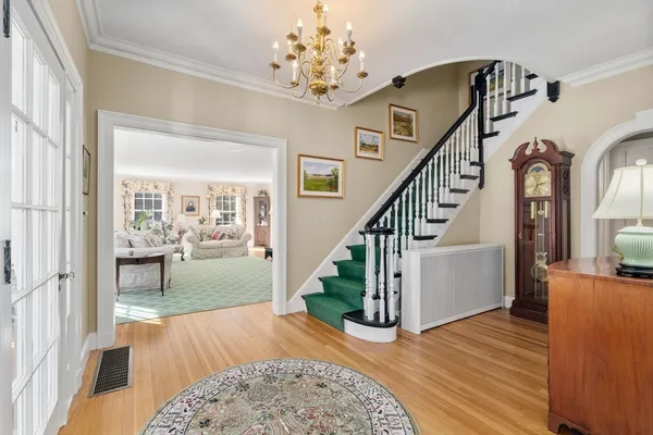 a view of entryway and hall with wooden floor