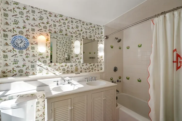 a bathroom with a shower toilet and sink
