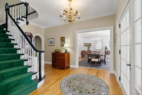 a view of a livingroom with furniture a dinning room and stairs