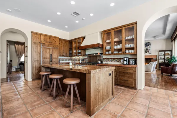 a kitchen with stainless steel appliances granite countertop a refrigerator and a sink