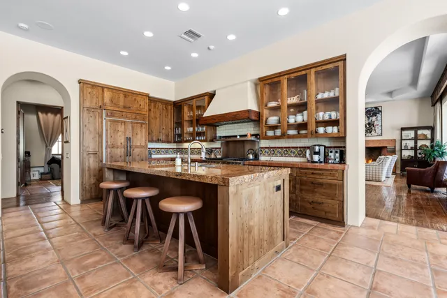 a kitchen with stainless steel appliances granite countertop a refrigerator and a sink