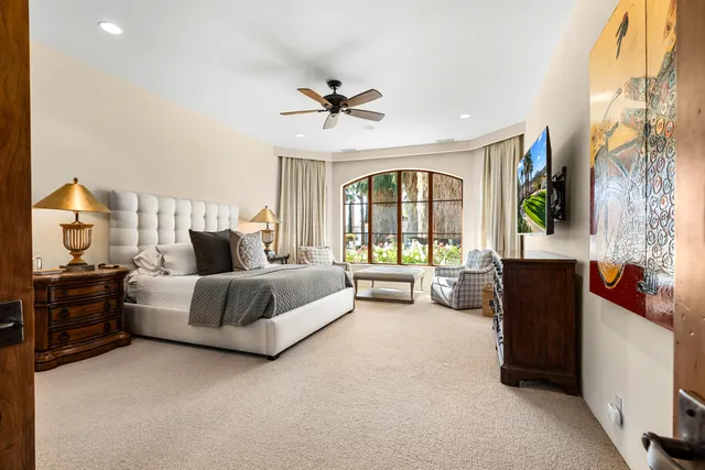 a spacious bedroom with a bed and a couch