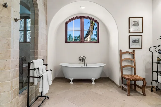 a bathroom with a bathtub and a window