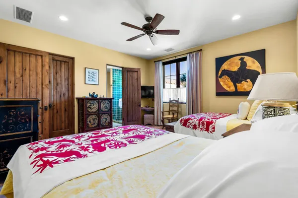 a bedroom with a bed and a chandelier