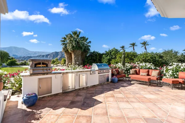 a view of a swimming pool with a patio and a fire pit